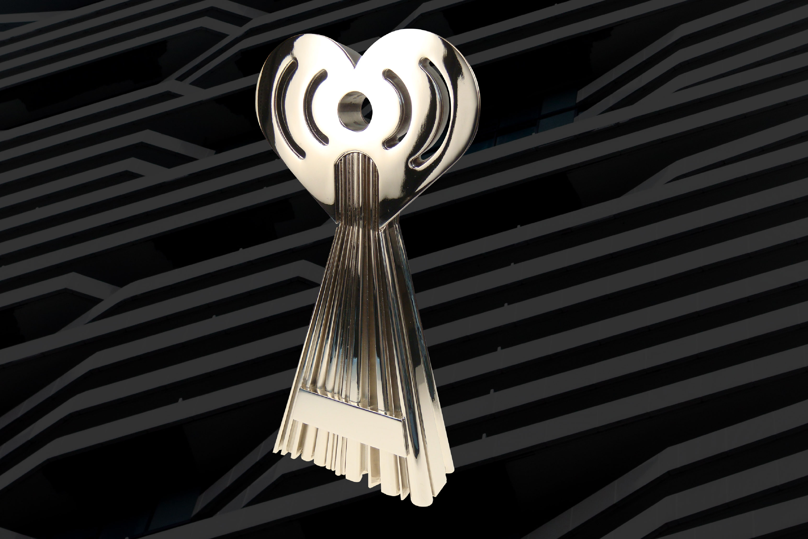 iHeartRadio Music Award shown at a front angle on a dark, abstract background