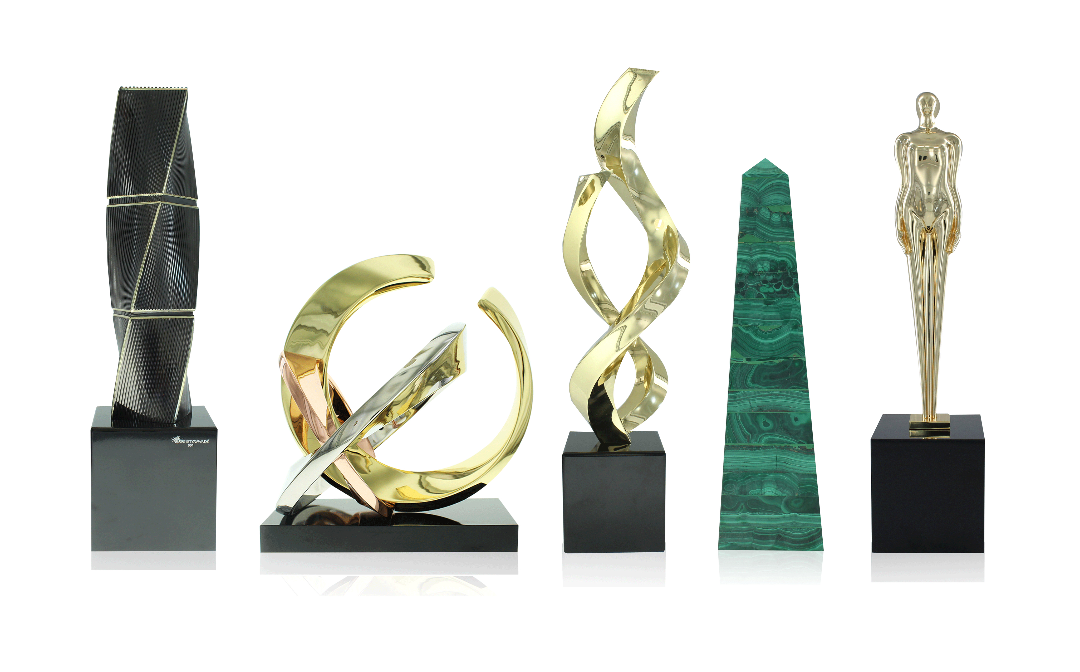 5 trophies from the World's First Limited Editions Collection of awards. From left to right: Twist Texture, Rings, Ribbons, Malachite Obelisk, Figure.
