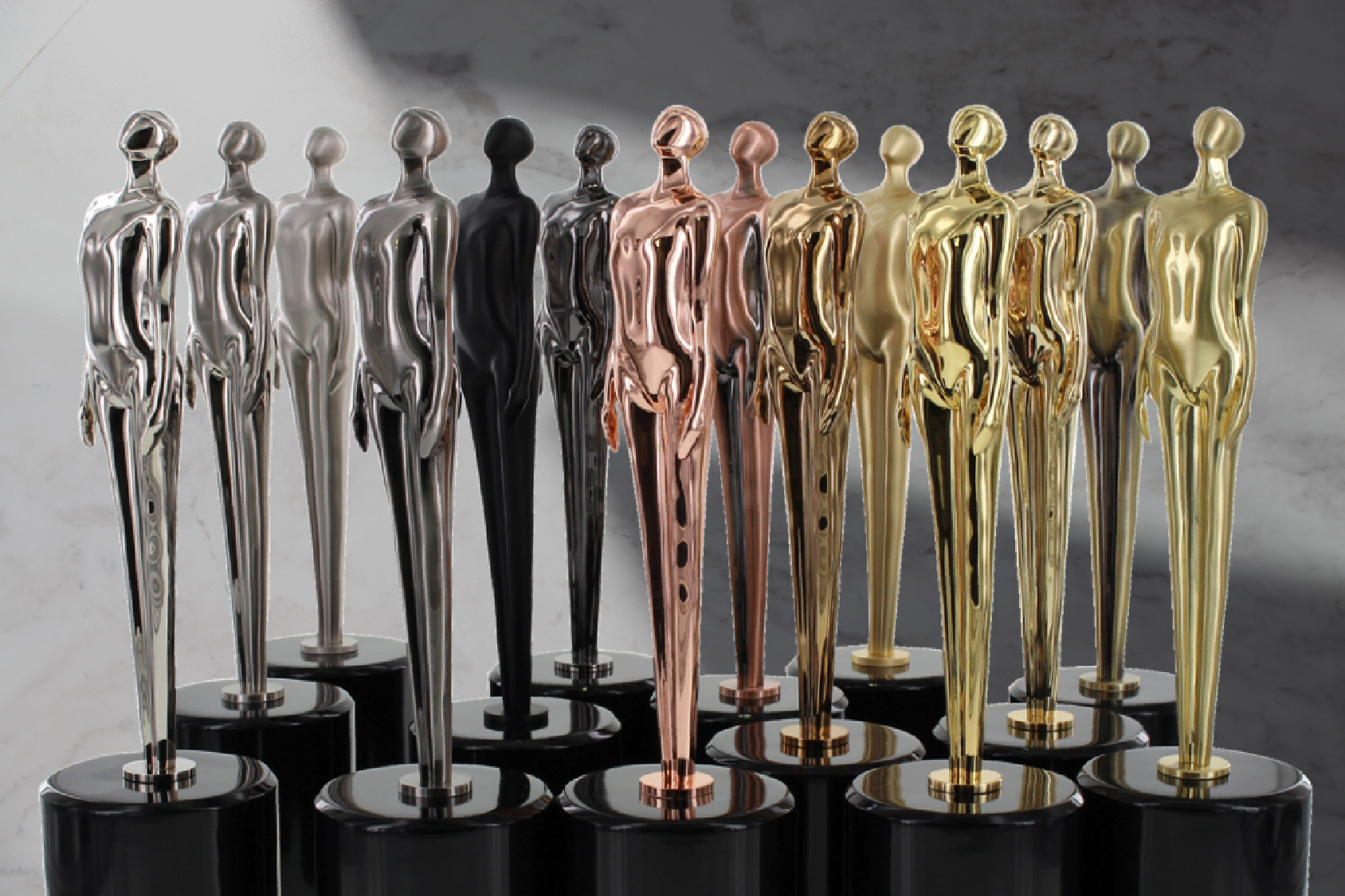 A collection of the Proud Form trophy in all different custom electroplated finishes