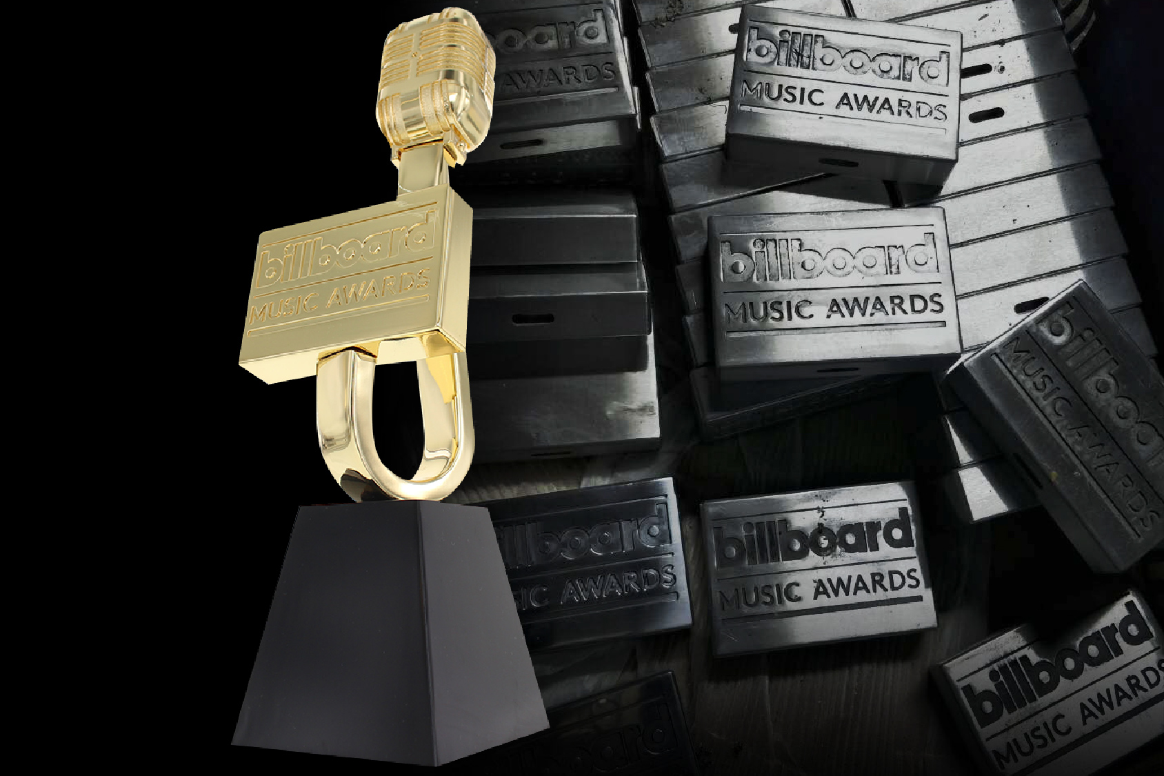 Billboard Music Awards trophy in front of machined plaques