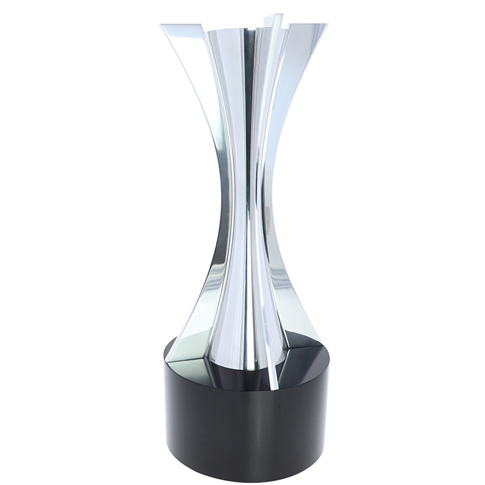 Elegant metal statue with precisely machined curves on a black base