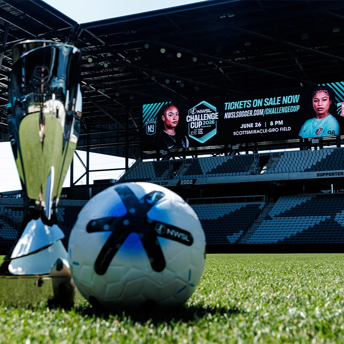 custom soccer trophy for the NWSL Challenge Cup sitting on a soccer pitch