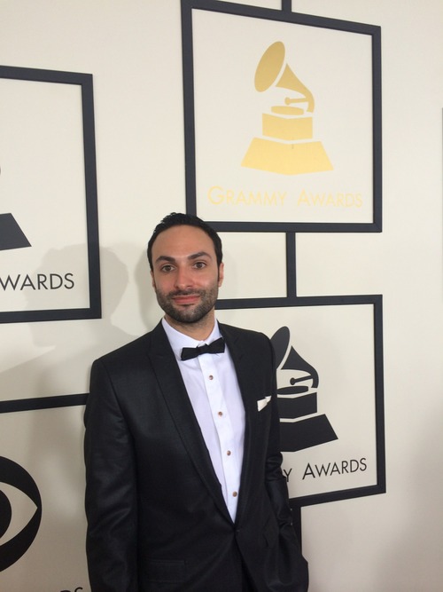 David Moritz, Founder and CEO standing on the red carpet at the Grammy Awards in a black tuxedo
