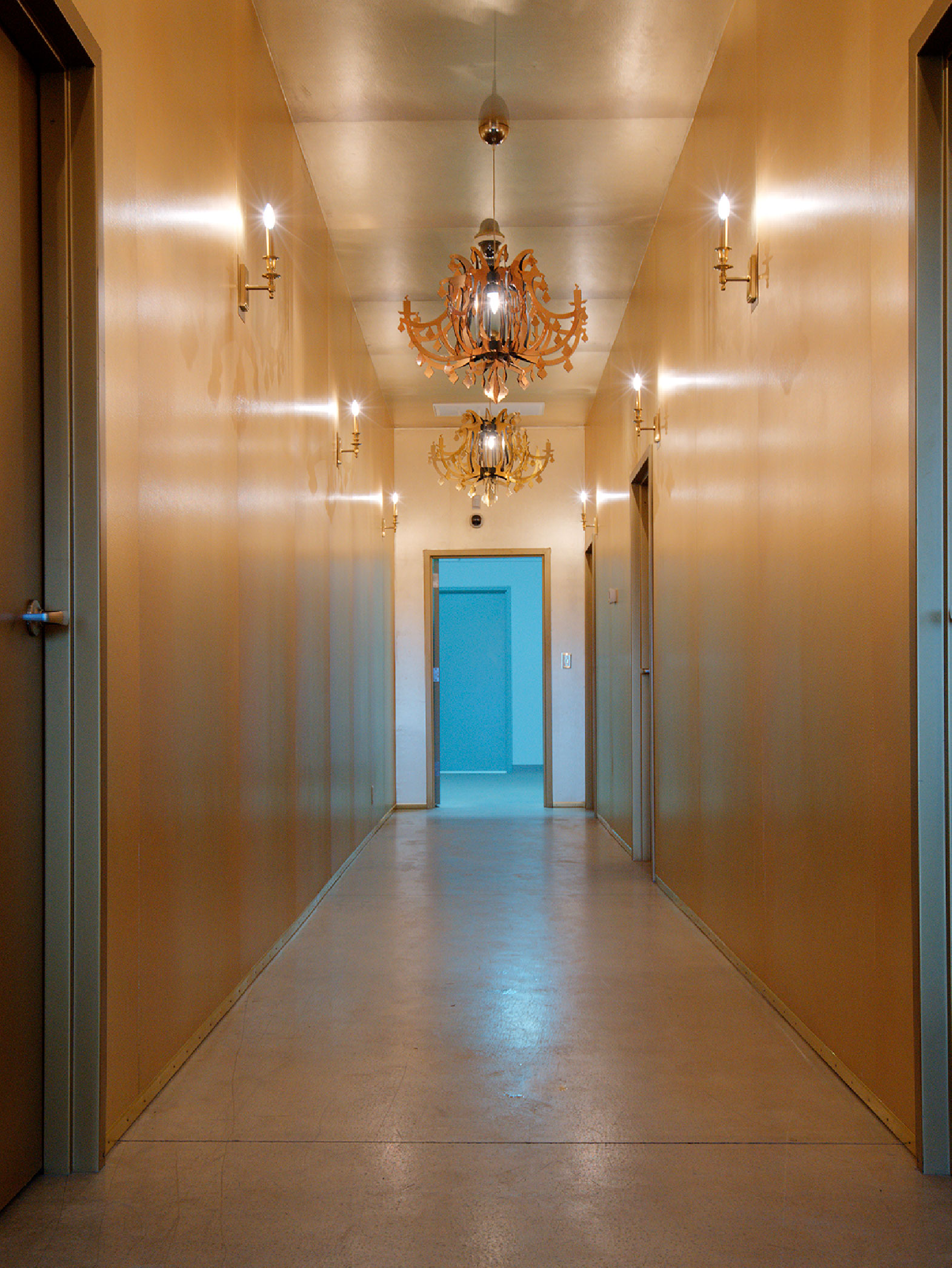 gold wrapped hallway with gold chandeliers