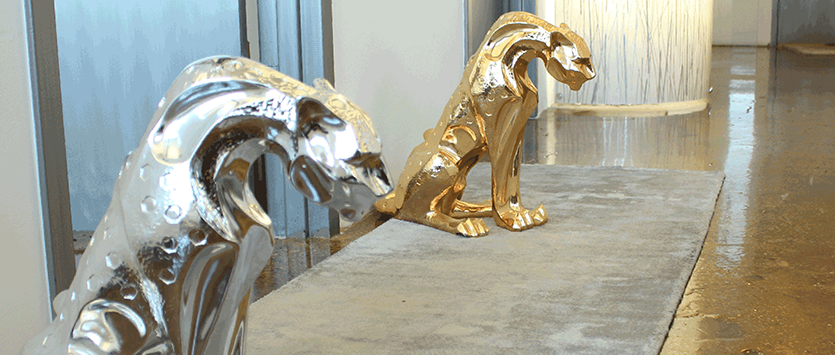 Metallic Jaguar Statues in Modern Space