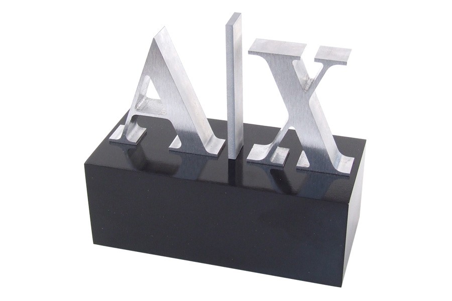 Armani Exchange logo trophy with machined cut out logo lettering on black acrylic base to honor employees with annual sales of one million dollars or more