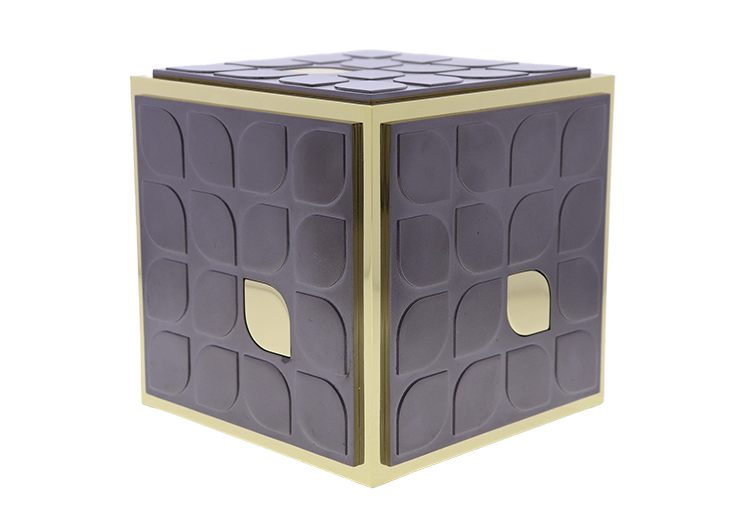 Custom gold cube with black squares covering the surface of each side with leaf-shaped outlines
