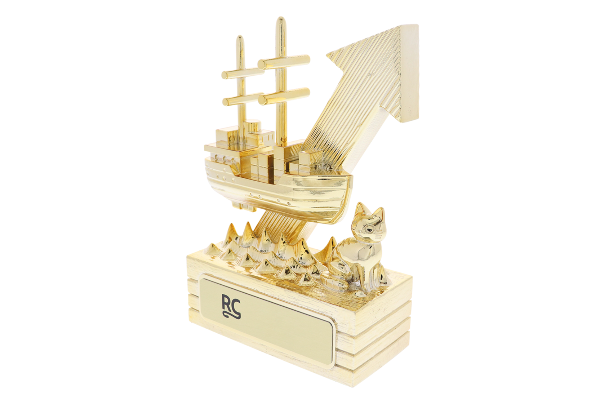 Detailed revenue award depicting a ship rising from the ocean, all in gold
