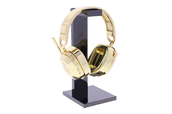 Custom gold headset hanging from a black stand