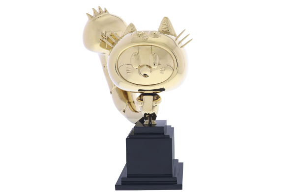 Gold cat mascot sitting atop a tiered black base
