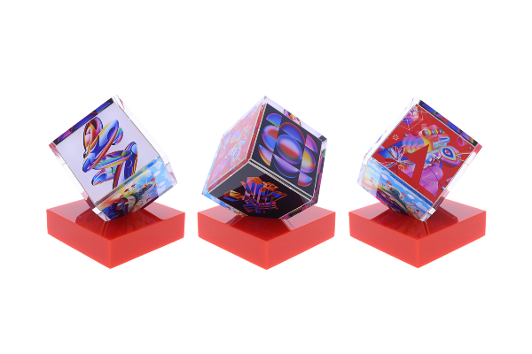 Spinning cube with unique graphics atop a red base