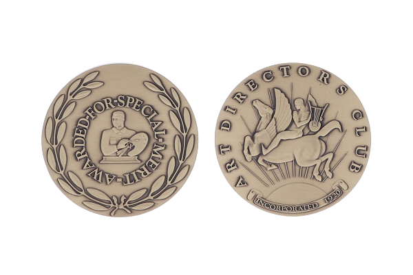 Two sided brass coin with intricate depictions