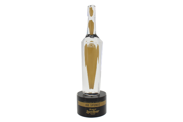 Custom bottle with gold detail atop a round black base