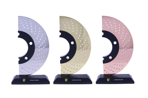 Gold, silver, and bronze car brake rotors atop black bases
