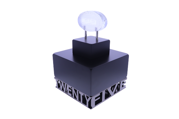 Crystal oval atop tiered black blocks with a cut-out of the words "twenty five"