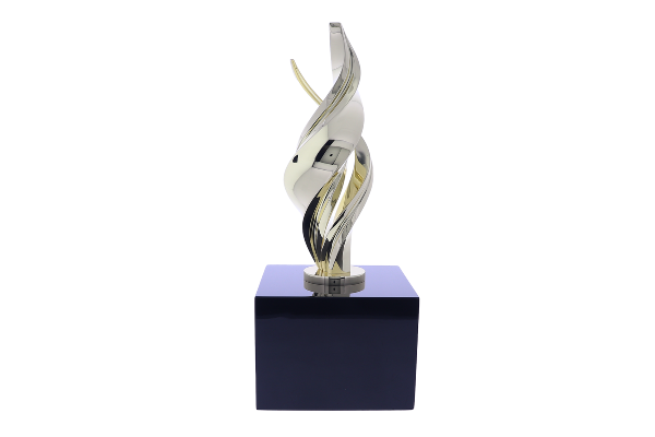 Flame sculpture made up of gold intertwining metal atop a black base