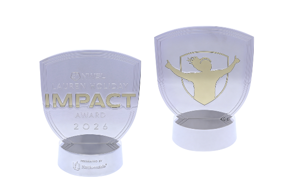 Shield-shaped double-sided silver trophy with text and the silhouette of a celebrating woman