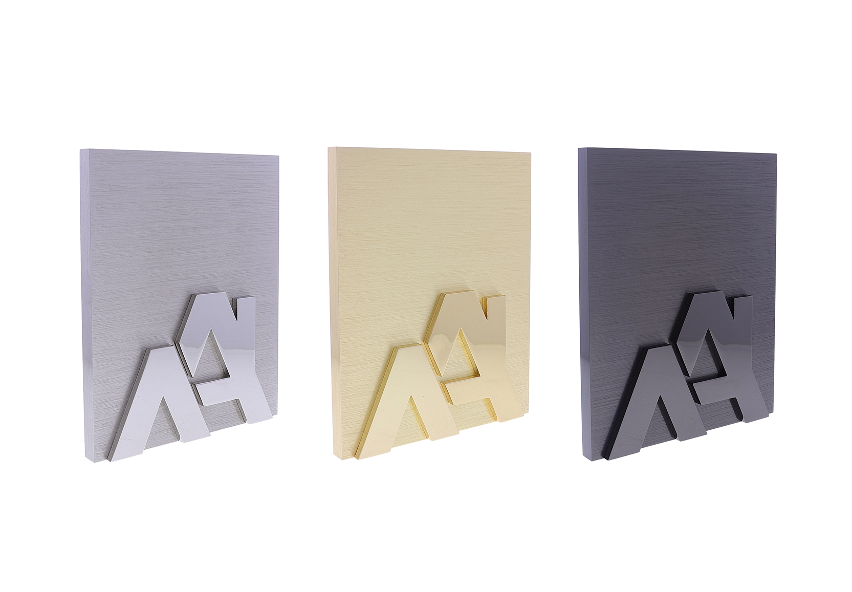 Silver, gold, and black plaques with two raised A