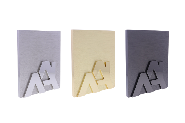 Silver, gold, and black plaques with two raised A's