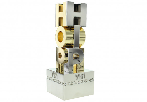 Pure aluminum award with intersecting letters and gold plating.
