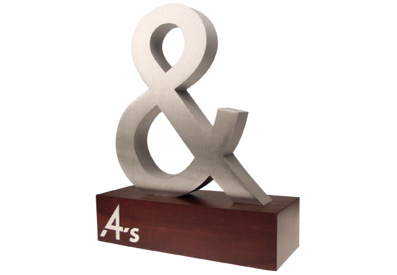 A custom machined aluminum ampersand mounted on a wood base.