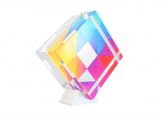 Acrylic award with colorful geometric pattern on an aluminum stand.