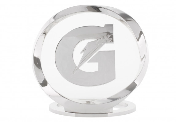 Custom metal trophy with the brand logo presented floating in a twisting ring form. This luxury award is used to honor an Athlete of the Year.