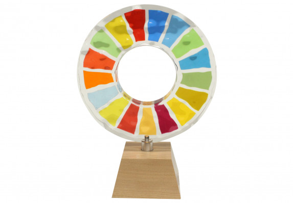 This custom-crafted award has a unique ring sculpture with color-matched segments and a water-top textured surface. This artful recognition piece is mounted atop a modern, tapered wood base and presented as part of a charitable foundation's awards program.