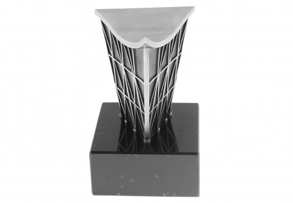 Custom cast metal trophy crafted for an educational institution focusing on technology. The form includes a model building presented on a black marble base.