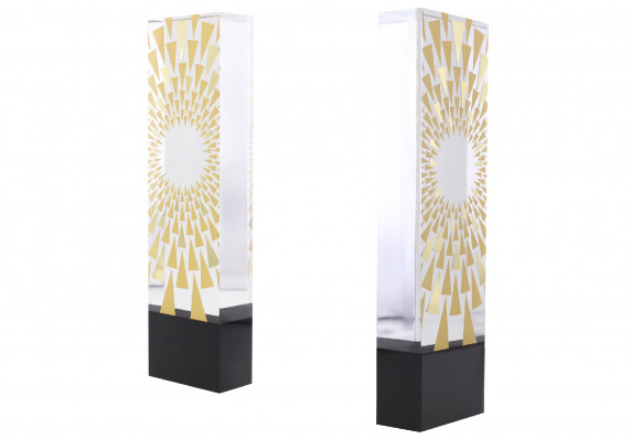 This pillar trophy is crafted from two pieces of high-end acrylic Lucite — one black and one clear — and is accented with gold metal cut-outs.
