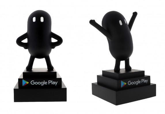 Custom gaming award made of zinc die-cast with a figure painted in matte black in hero pose and celebration pose on a three-tier stepped base.