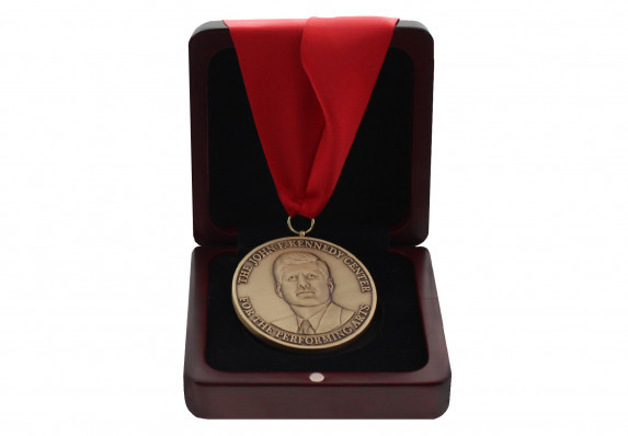 A custom-crafted medal with exceptional relief of JFK presented in a high-end wood box.