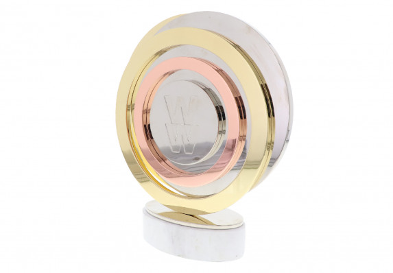 A custom metal logo award mounted on a marble base.