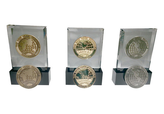 Lucite embedment awards with globe medallion on black base