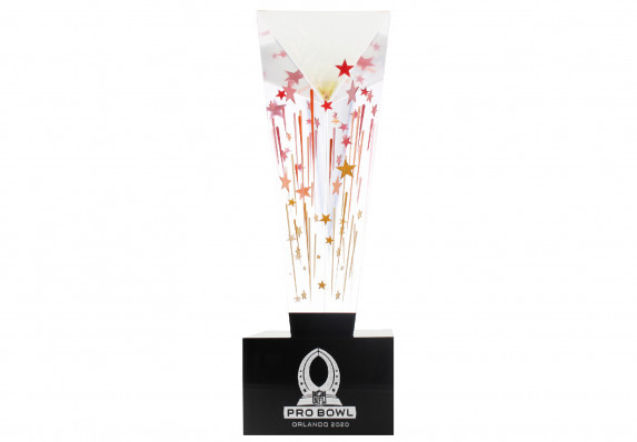 A custom Lucite acrylic trophy with a tall sculptural form with etched and color-filled shooting stars on a black base with silver logo.
