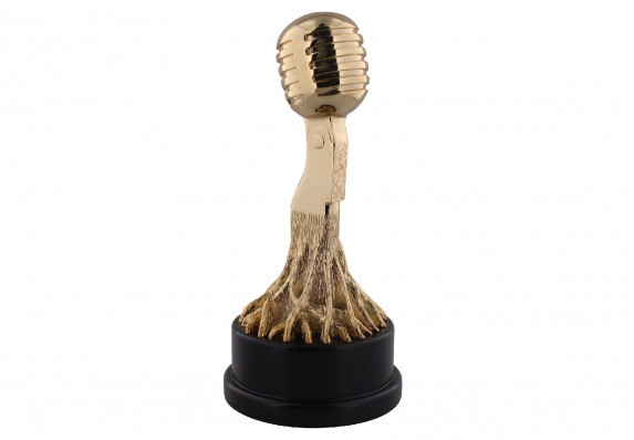 A custom gold sculpture in the form of a microphone with roots growing from its base. This incredible luxury trophy is an iconic form.