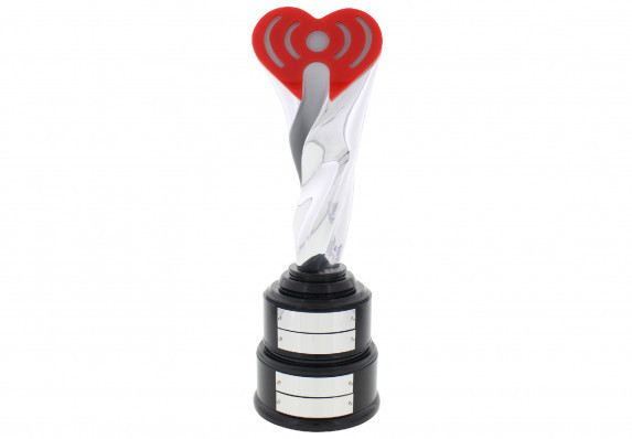 A luxury custom metal award crafted for media brand. The form incorporated a twisting silver chrome sculpture with the silhouette of a trophy cup. This is capped with a color logo and is mounted on a stepped perpetual trophy base.