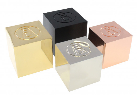 Cast metal awards in the shape of perfect cubes with inset logo detail. Different finishes are used to distinguish between levels of achievement.