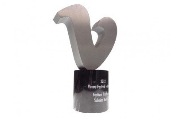 Custom logo award in metal, mounted on marble base.