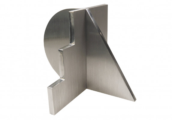 Machined metal trophy with brushed surfaces and polished edges.