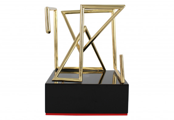 A custom trophy crafted in shiny gold in the shape of the awards program's geometric logo for motion design.