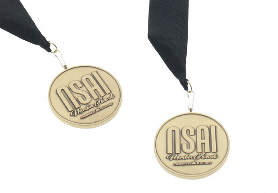 Matte gold medal for a prestigious songwriters association. This custom cast medallion is a luxury piece of recognition presented on an elegant black ribbon.