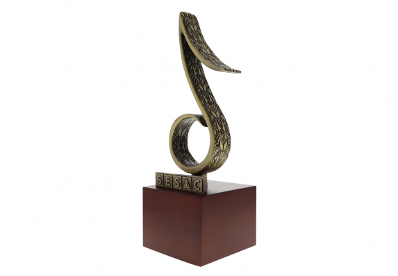 Cast pewter trophy in the shape of a music note with an intricate Art Deco style pattern on the sides.