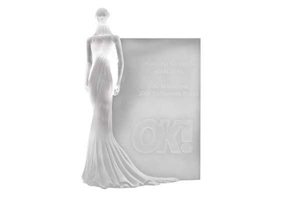 Lost wax cast custom crystal award. A 3-Dimensional woman in an elegant gown standing in front of a plaque.