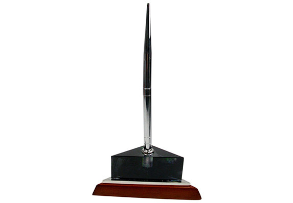 Pen stand in cast crystal pate de verre. Custom corporate gift with multiple colored crystal, shiny silver metal accent and a wood base.