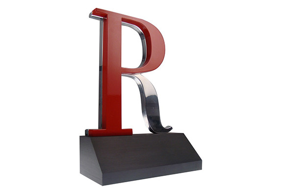 Custom machined letters are hand-assembled on a modern awards base to make this elegant trophy.