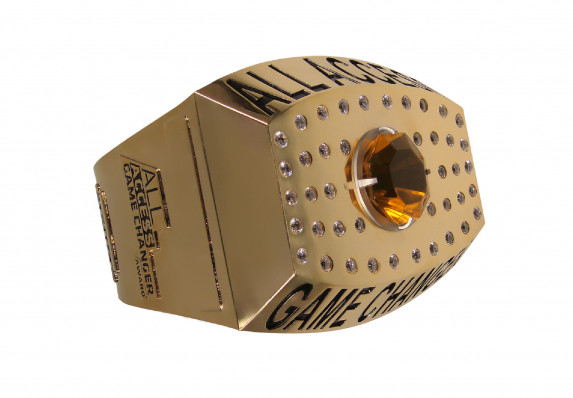 A massive, gold metal ring trophy with inlaid crystal gems.