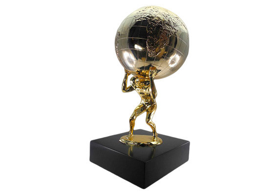 Metal figure holding up a globe, both plated in gold. Mounted on black base.