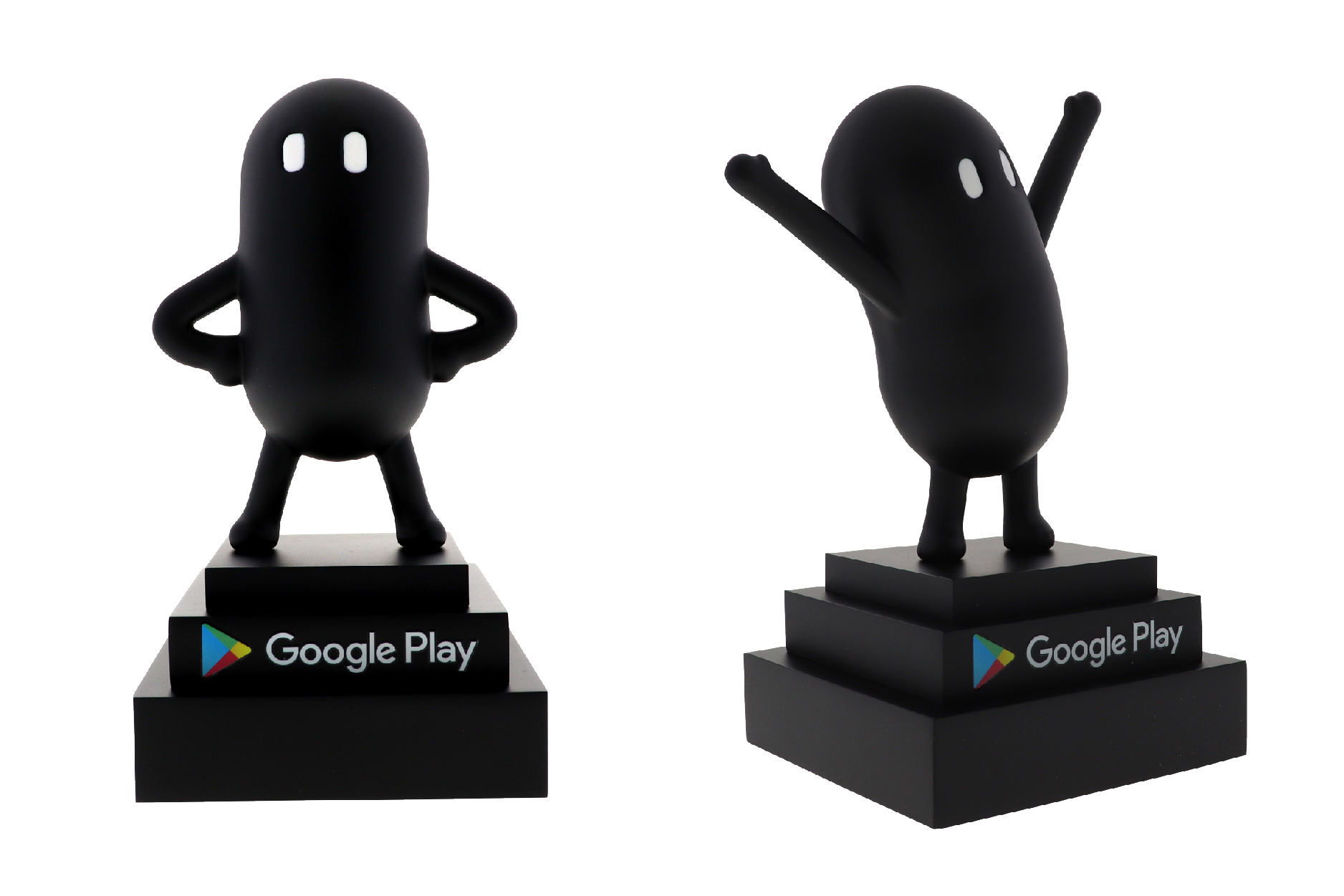 A figure painted in matte black in hero pose and celebration pose on a three-tier stepped base.