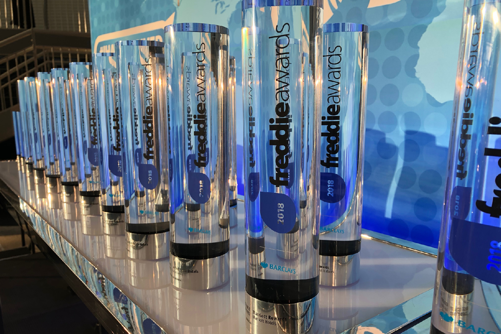 Custom acrylic Freddie Awards lined up on a table